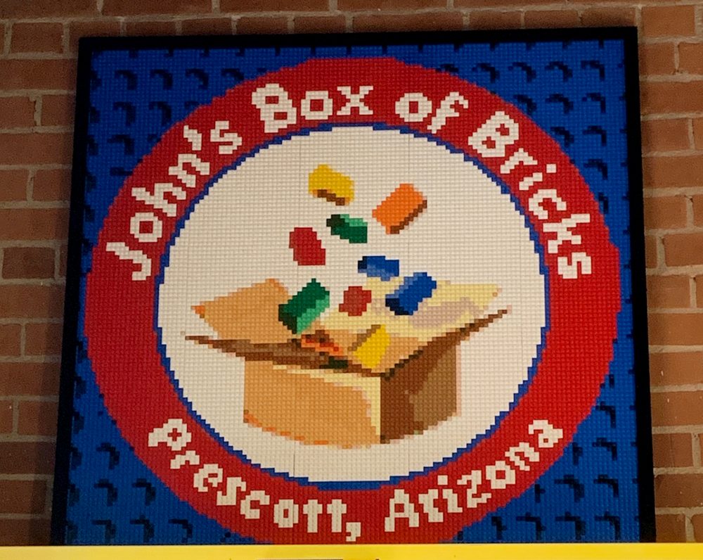 Pre-assembled brick mosaic sections packed in organized trays ready to hang