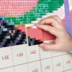 Close-up of a printed, numbered baseplate being built by hand