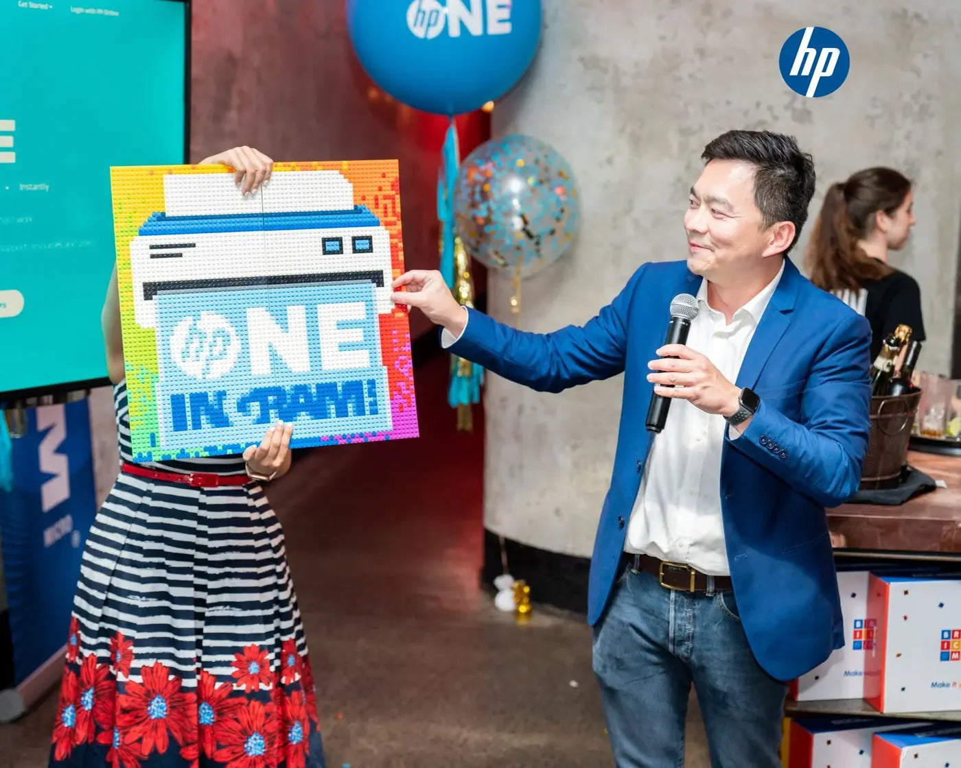 A finished HP ONE brick mosaic revealed on stage at a launch event